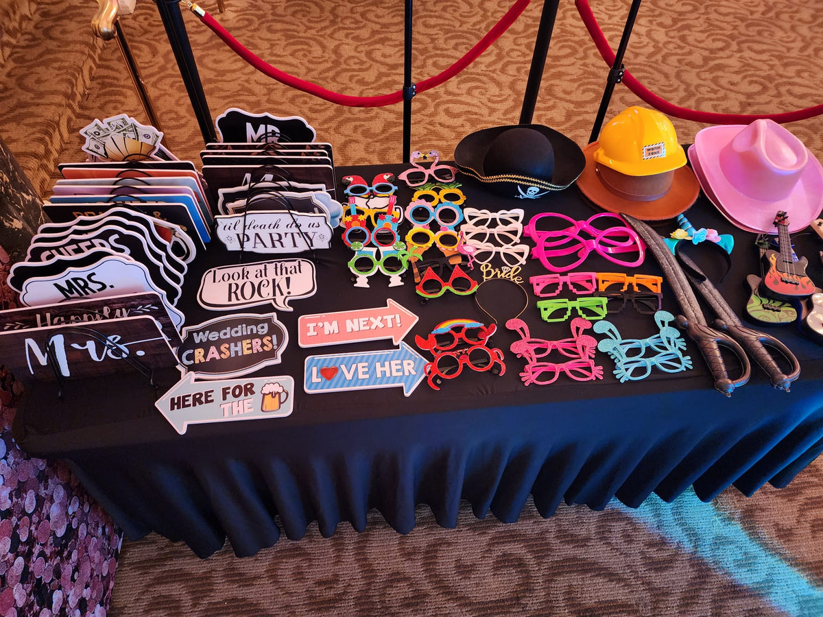 Photo booth props table with fun accessories for guests